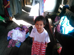 A little girl from Chin State in her new hand made dress.