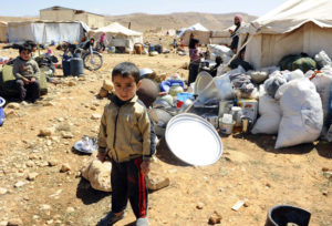 A Syrian refugee child who fled the violence from the Syrian town of Flita, near Yabroud, poses for a photograph at the border town of Arsal, in the eastern Bekaa Valley March 20, 2014. Tensions have been especially high in and around Arsal after Syrian forces and the Lebanese Shi'ite militant group Hezbollah recaptured the Syrian border town of Yabroud from rebels on Sunday, sending a stream of refugees and fighters across the border. Lebanon's border area has been steadily sucked into Syria's three-year-old conflict as President Bashar al-Assad's forces attack nearby rebel bases and suspected Syrian rebels fire rockets at Shi'ite towns to punish Hezbollah for sending fighters to support Assad. REUTERS/Hassan Abdallah (LEBANON - Tags: POLITICS CIVIL UNREST) - RTR3HY4X
